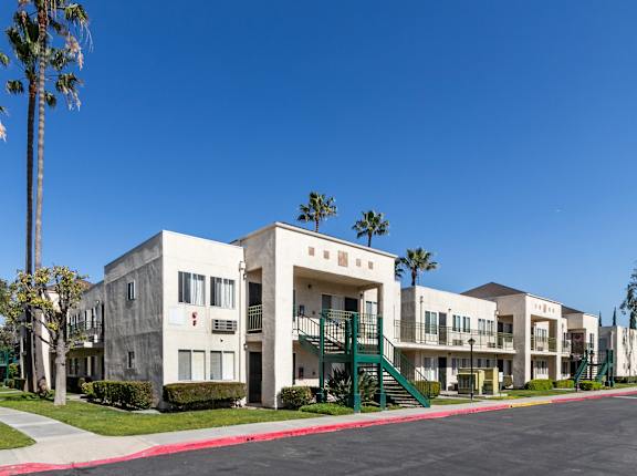 Apartment complex with a red line down the center of the street. at Whispering Fountains Lakewood, Lakewood Bar California