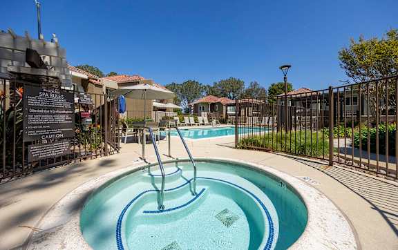 Spa and pool area with lounge seating at Bella Del Mar Apartments, Del Mar, CA