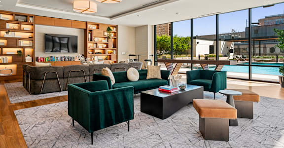 A living room with a green couch and a television.
