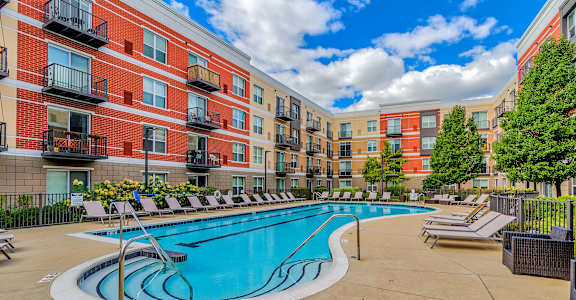 our apartments offer a swimming pool with lounge chairs at Avant at the Arboretum, Lisle, IL