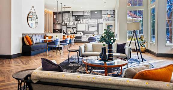 a living room with couches and a table at The Olivine in North Austin, Texas