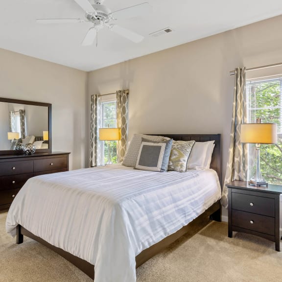 a bedroom with a bed and a ceiling fan