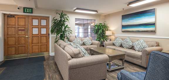 a living room with couches and chairs and a table at Huntington Terrace North Senior, California, 92648