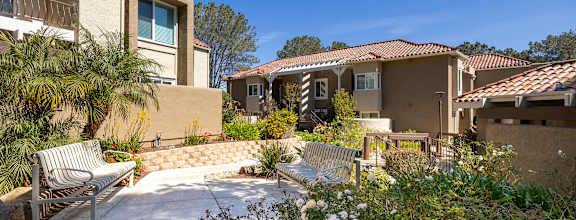 Courtyard seating area with tiered retaining wall at Bella Del Mar Apartments, Del Mar, CA