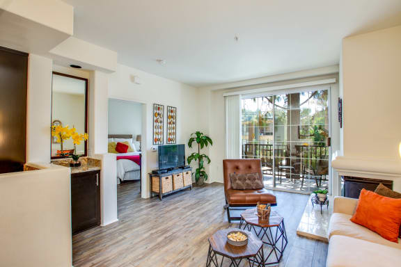 a living room with a couch and a tv and a balcony at L'Estancia, Studio City, CA, 91604