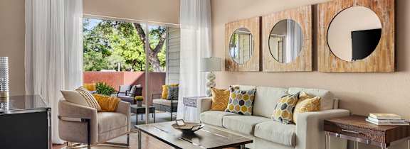 A living room with a white couch and a coffee table.