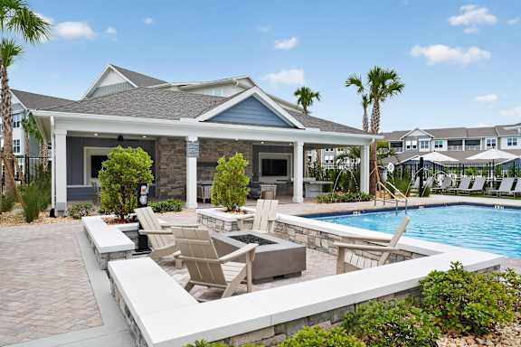 A house with a pool and patio furniture.