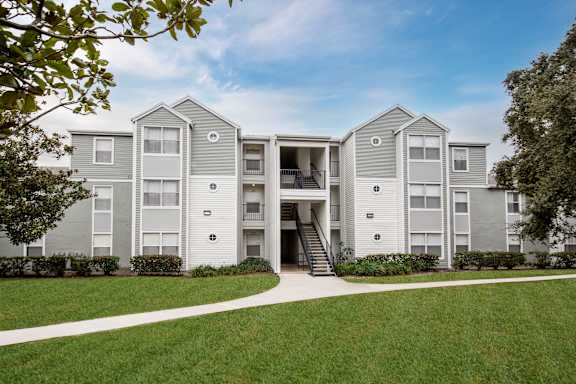 Apartment building with a green lawn in front.