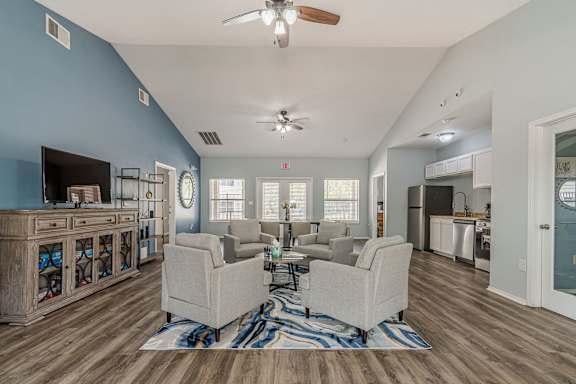 a living room with a couch and a coffee table in front of a dining roomat The Springs, Pasadena Texas