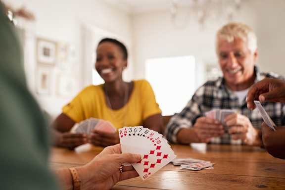 Older people playing cards at Sweetwater Terraces Apartments, Georgia, 30096