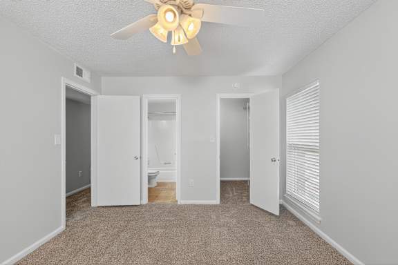 A room with a window and carpeted floor. at North Bluff Apartments, North Charleston