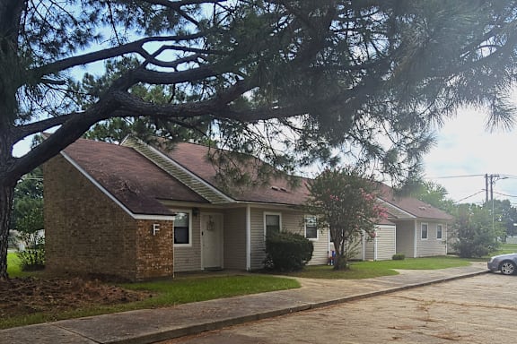 A house with a tree in front of it.