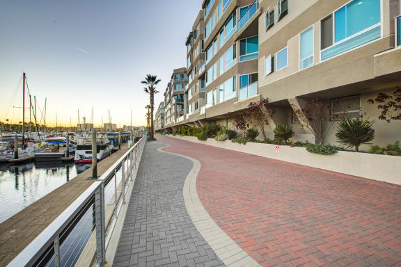 a walkway next to a harbor with boats  at Esprit Apartments, Marina del Rey, 90292