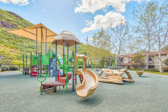 a playground with slides and other toys in a park  at Mission Hills, Camarillo, CA