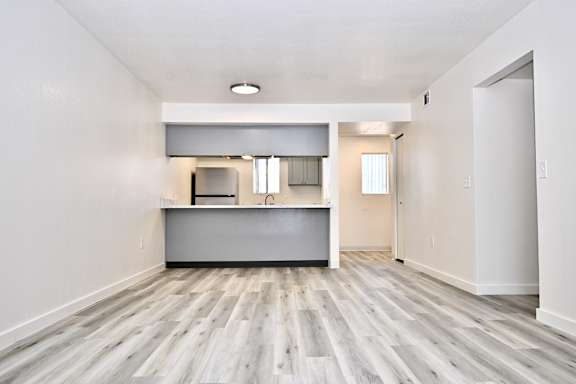 A kitchen with a white counter top and a sink.