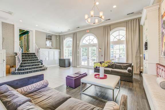 A living room with a staircase and a couch.