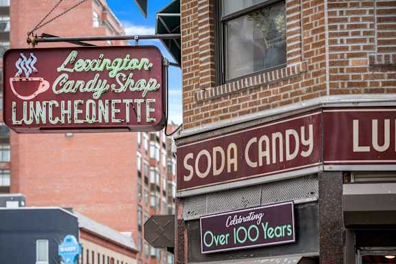 A brick building with a sign that says Soda Candy.