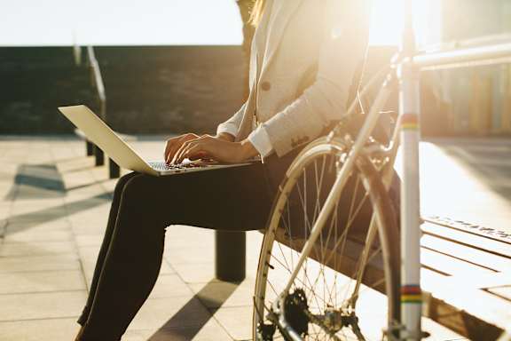 A person in a wheelchair is using a laptop. at The Fowler Apartments, Boise, ID