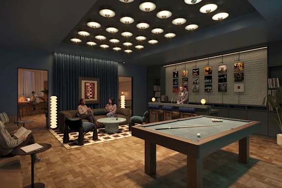 A man and woman are sitting in a room with a pool table.