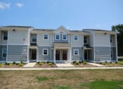 Thumbnail 1 of 3 - front view of an apartment building with sidewalks and grass