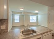 Thumbnail 6 of 6 - a kitchen with granite counter tops and a sink