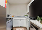 Thumbnail 10 of 17 - A kitchen with a stainless steel refrigerator and white cabinets.at Signature Collection, Tuscaloosa