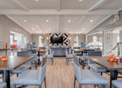 Thumbnail 5 of 7 - A modern dining room with a long table set for six.