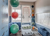 Thumbnail 2 of 7 - A gym with a green and red ball hanging from the ceiling.