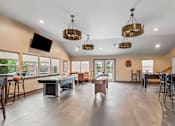 Thumbnail 2 of 8 - A spacious room with a pool table and a television.