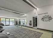 Thumbnail 2 of 6 - A gym with a sign that says "The only bad workout is the one you didn't do".