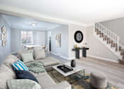 Thumbnail 2 of 3 - A living room with a grey couch and a coffee table.