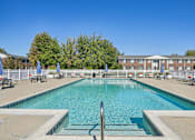 Thumbnail 3 of 4 - A large swimming pool with a metal ladder in the middle.