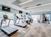 Thumbnail 4 of 6 - A gym with treadmills, exercise equipment, and a sign that says "POWER".