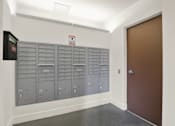 Thumbnail 18 of 41 - A row of mailboxes are lined up against a wall.
