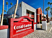 Thumbnail 1 of 8 - A red sign that says Coral Gardens Apartment Homes.