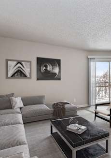 a living room with a couch and chairs and a table at Eastwood Crossings in Kansas City, Missouri
