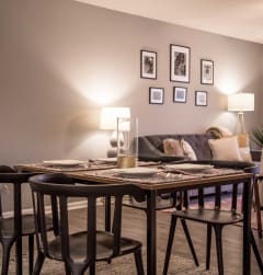 a dining room with a table and chairs and a couch