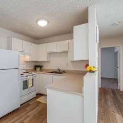 A kitchen with white appliances and wooden floors. at Hill Valley Apartments, Novato