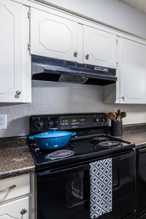 a kitchen with black appliances and white cabinets
