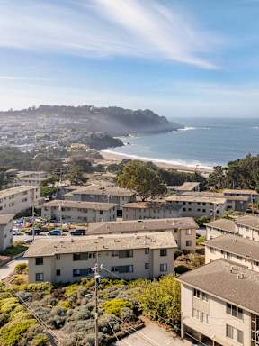A coastal residential area with houses and a beach.