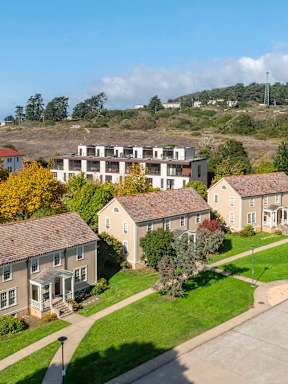 A row of houses with a road in between them.
