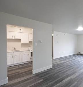 an empty living room and kitchen in a new home