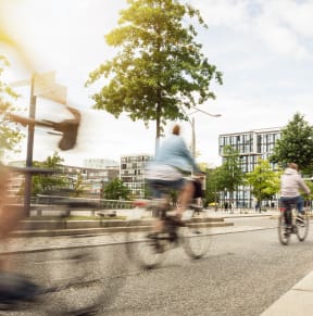 a group of people riding bikes down a city street