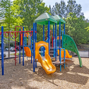 a playground at a park with slides and other playground equipment