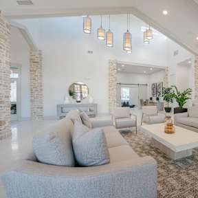 A modern living room with a grey sofa and a coffee table.