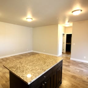 an empty living room with a kitchen island