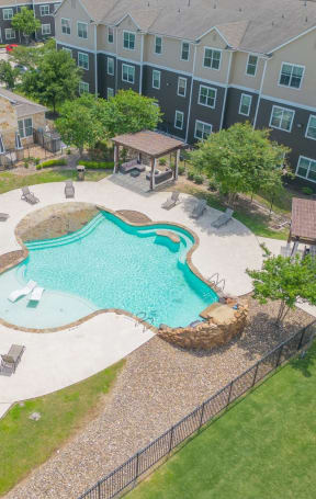 an aerial view of an apartment complex swimming pool