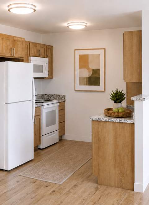 A kitchen with wooden cabinets and white appliances.
