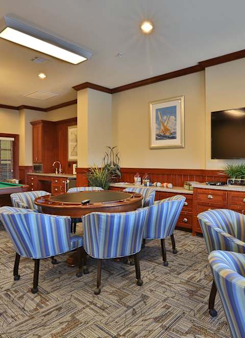 a billiards room with tables and chairs and a television