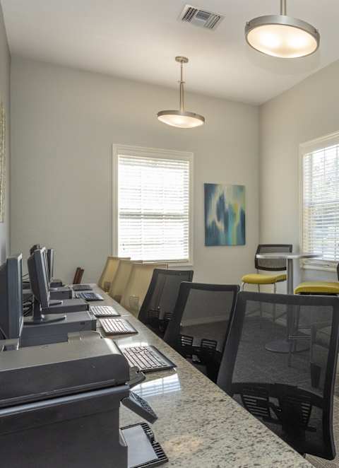 Community Living room with a fireplace at Sunrise Pointe, Port Orange, FL, Florida